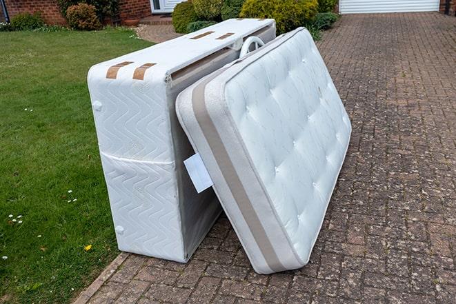 pickup truck filled with old mattresses for disposal